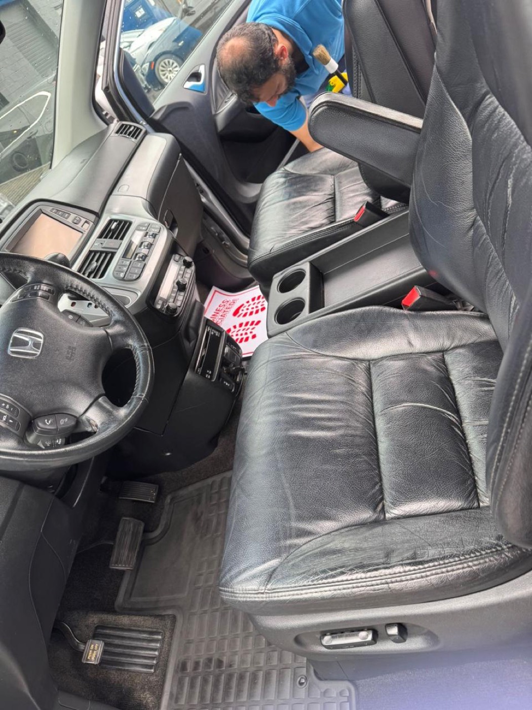 MaplXpress technician detailing a leather seat interior