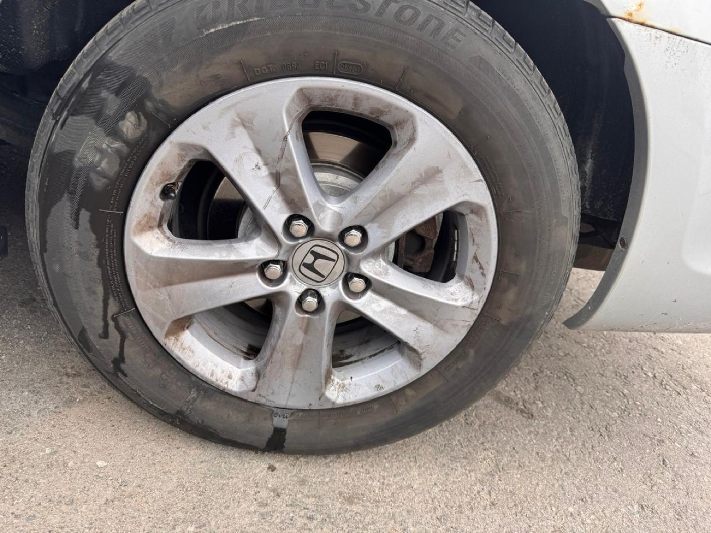 Car wheel covered in brake dust before, and clean and shining after detailing โ before